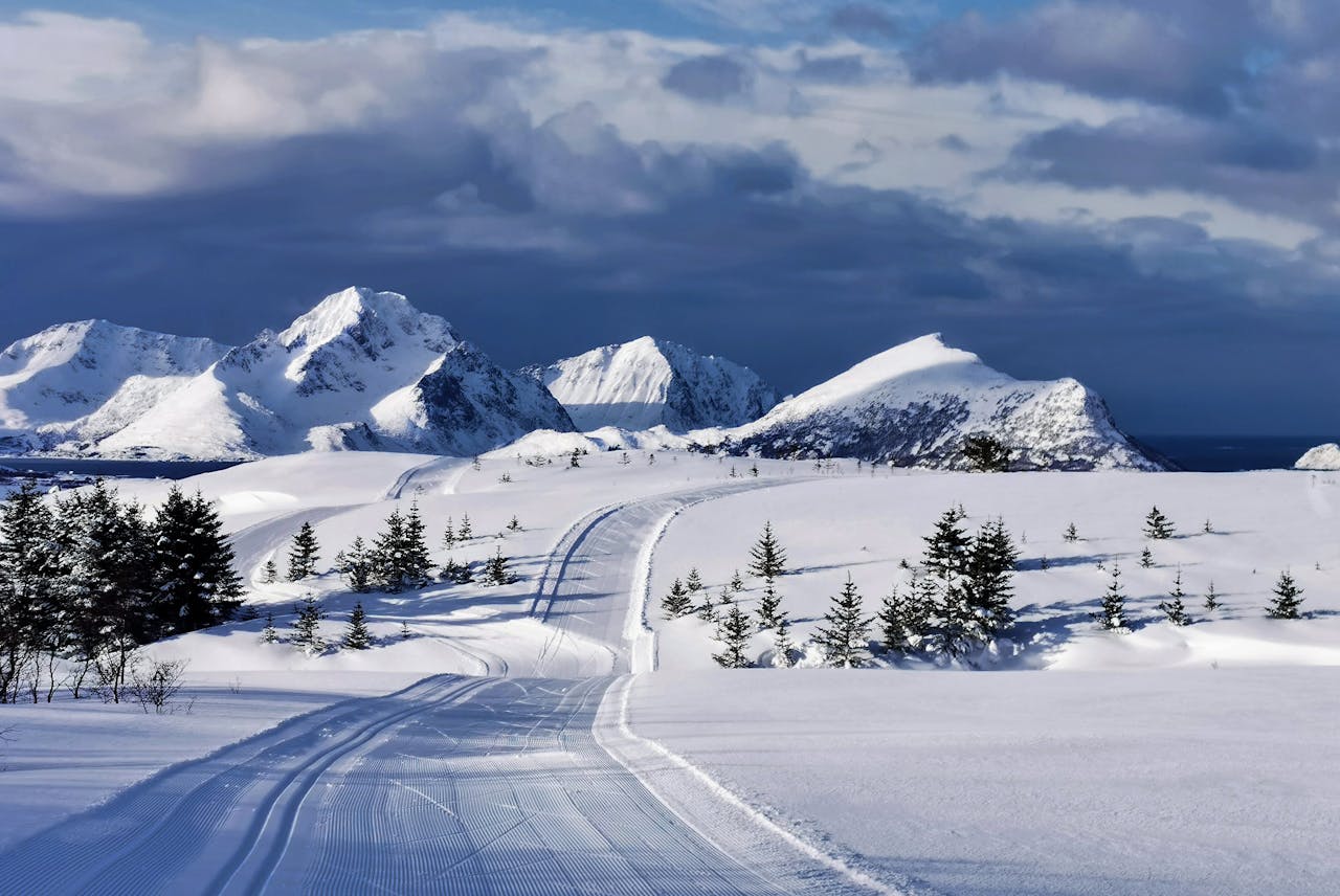 Tranquil snowy mountains and ski tracks in Lofoten, Norway's winter scenery.