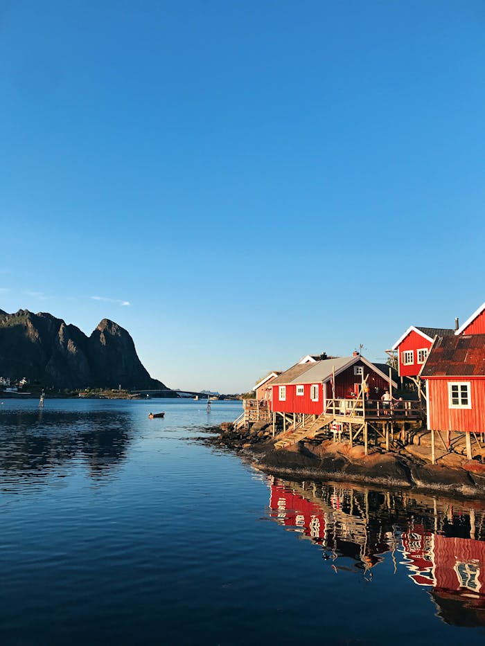 Charming red houses by the sea in Norway's Lofoten Islands, perfect for travel inspiration.